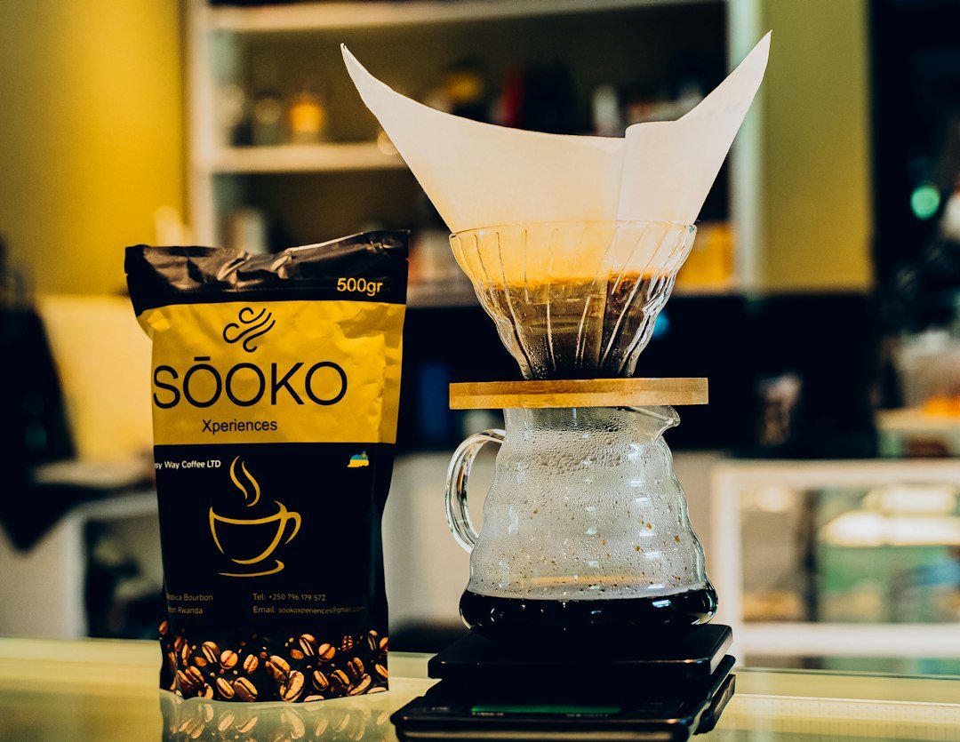 Coffee beans beside a pour-over coffee setup.