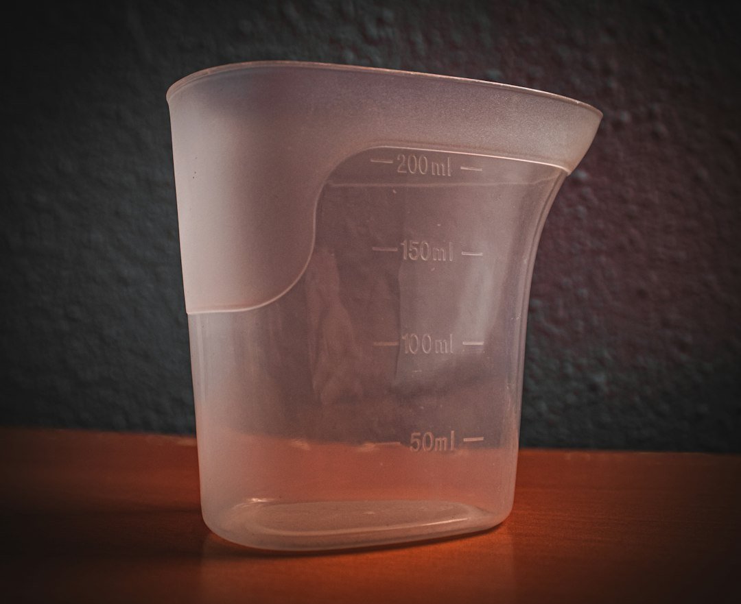 White plastic measuring jug marked in milliliters.
